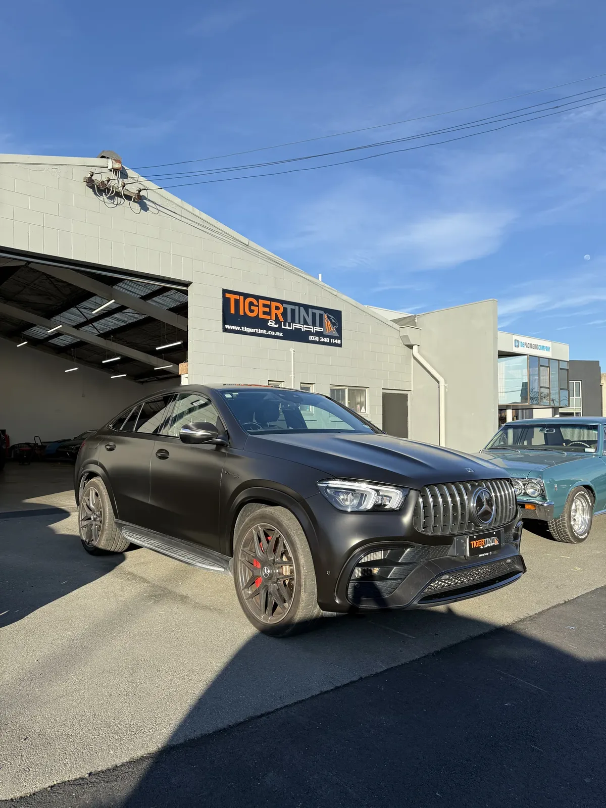 Matte black Mercedes-AMG GLE 63 with tinted windows outside the Tiger Tint & Wrap workshop