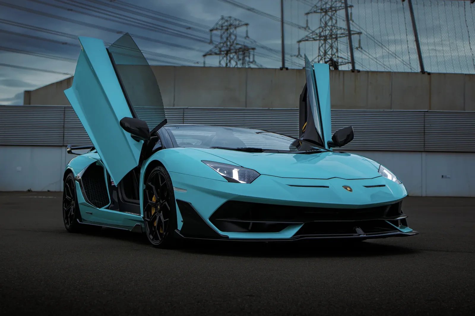 Teal Lamborghini Aventador SVJ with doors up after a colour change at Tiger Tint & Wrap Christchurch