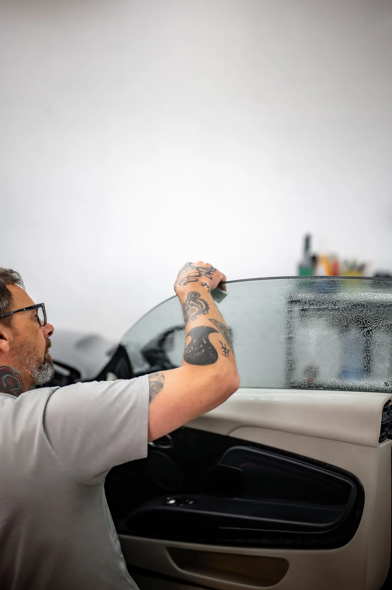 Sean installing window tint on a vehicle at the Tiger Tint & Wrap workshop